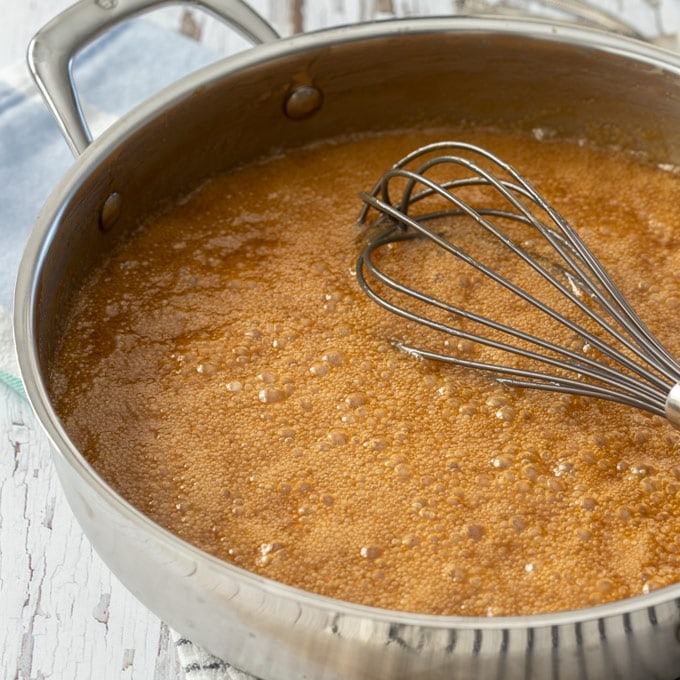 A pan of caramel sauce, bubbling