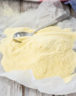 A piece of baking paper with yellow custard powder piled on top