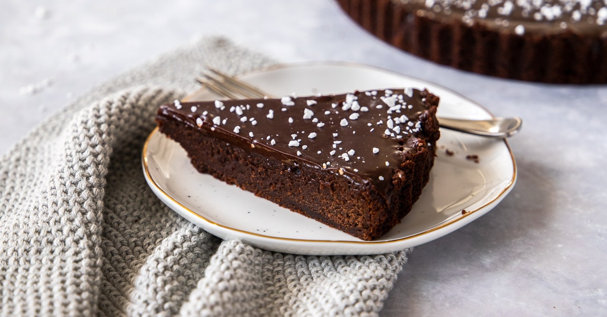 closeup side shot of a slice of chocolate brownie tart
