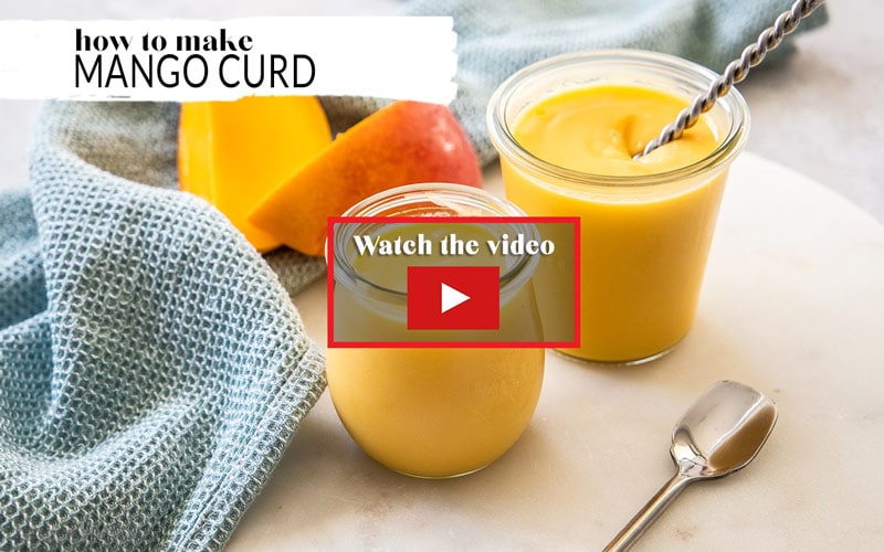 Mango curd in 2 jars, with a video play button over the top