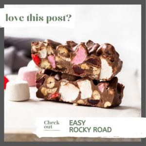 Slices of rocky road on a white board surrounded by marshmallows and candy