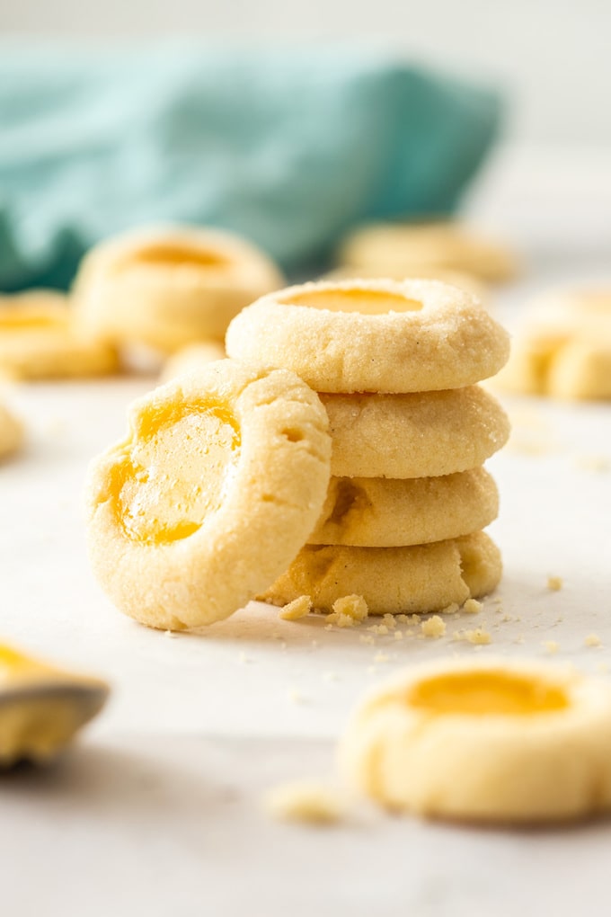 A stack of lemon curd cookies with one leant up against them.
