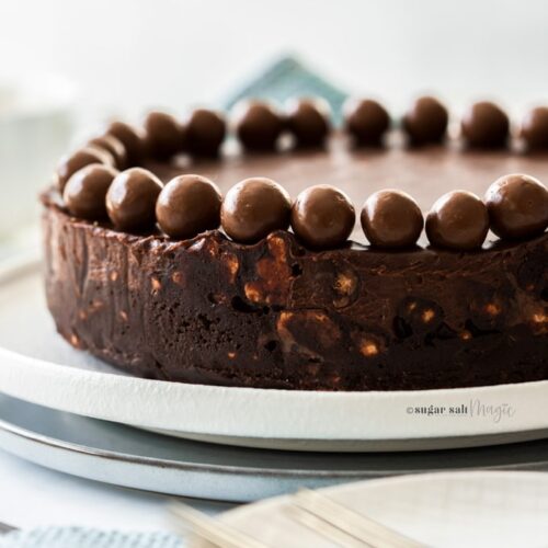 Closeup of the side of a chocolate fridge cake topped with maltesers
