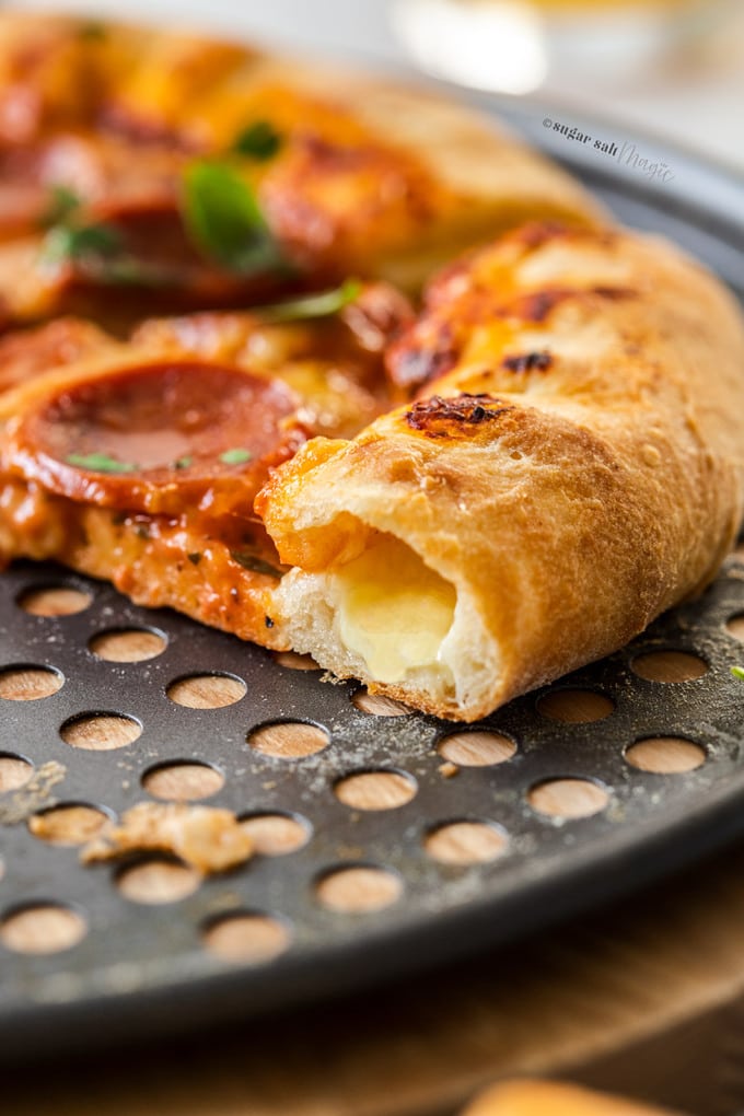 Closeup of the inside of the crust of a stuffed crust pepperoni pizza