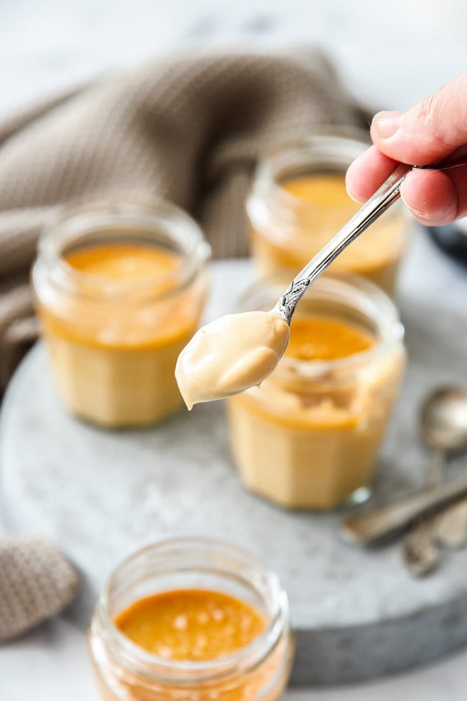 Close up of a spoon loaded with caramel custard