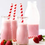 3 bottles of strawberry milk on a marble platter
