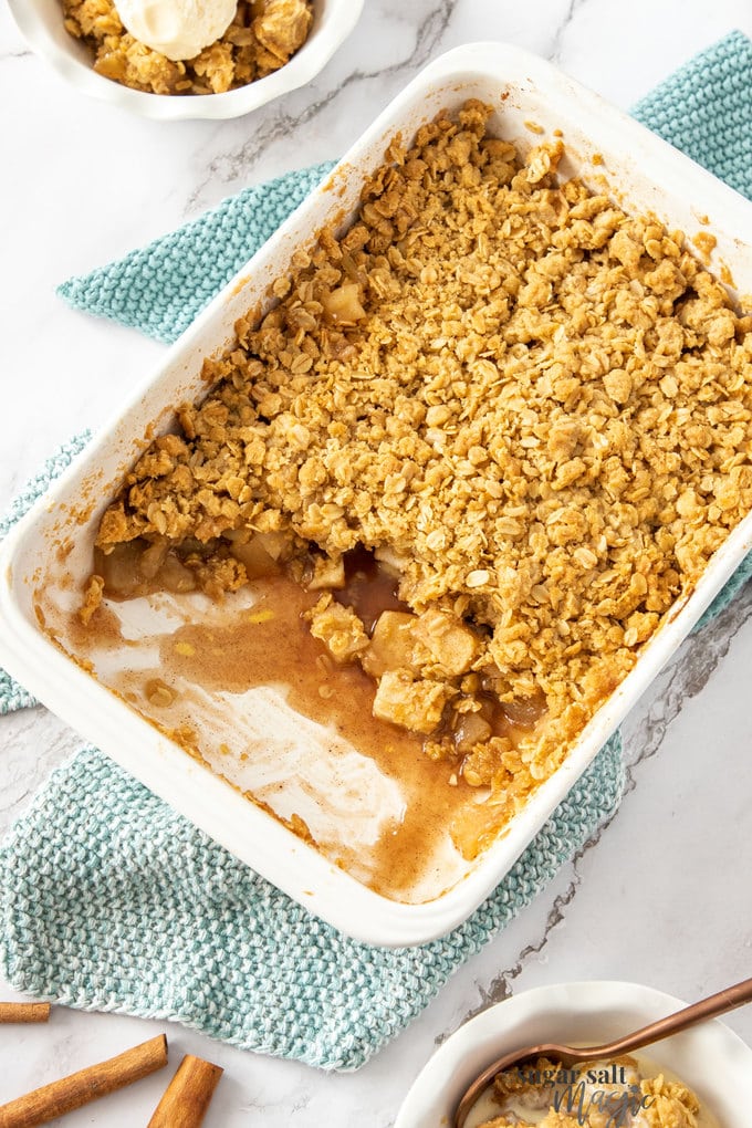Top down view of apple crumble in a white rectangular dish