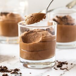 Chocolate mousse in a glass with a spoon taking some out