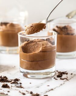 Chocolate mousse in a glass with a spoon taking some out