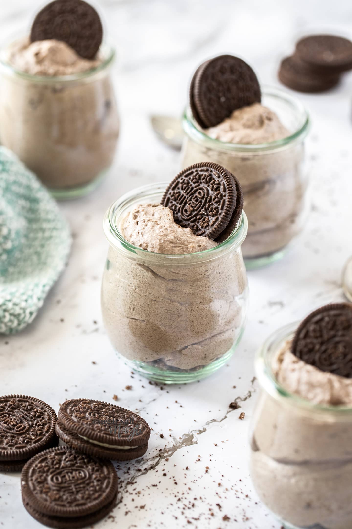 4 glass jars filled with mousse with an oreo on top of each