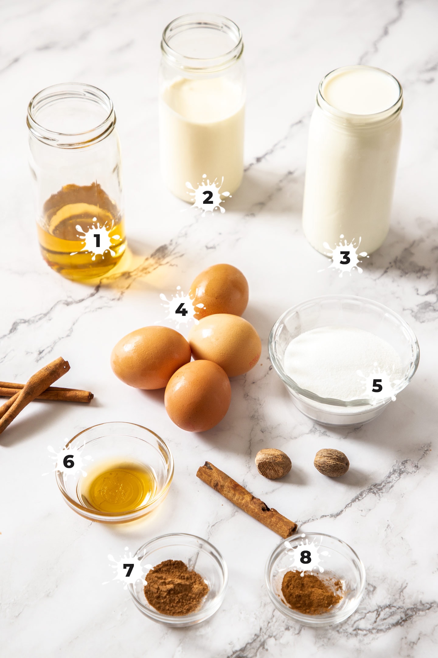 Ingredients for eggnog on a marble bench top