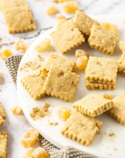 A batch of ginger shortbread surrounded by candied ginger