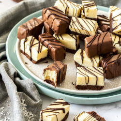 fudge bites, some covered in chocolate, on a cream coloured plate