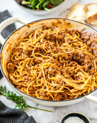 A white casserole dish filled with spaghetti bolognese
