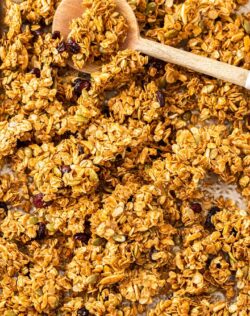 A gold baking tray filled with granola clusters