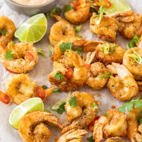 a batch fried prawns with chilli and green onion slices