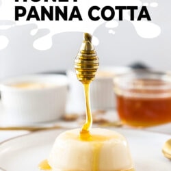 Honey being drizzled onto a panna cotta on a white plate
