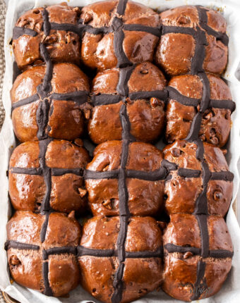 12 chocolate hot cross buns in teh tray they were baked in.