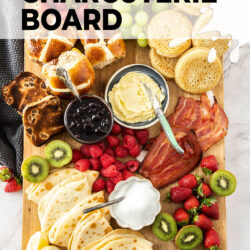 A wooden board filled with breakfast foods.