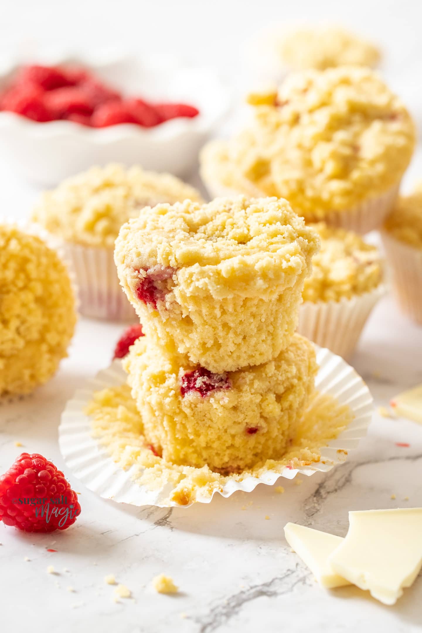 A stack of two raspberry white chocolate muffins.