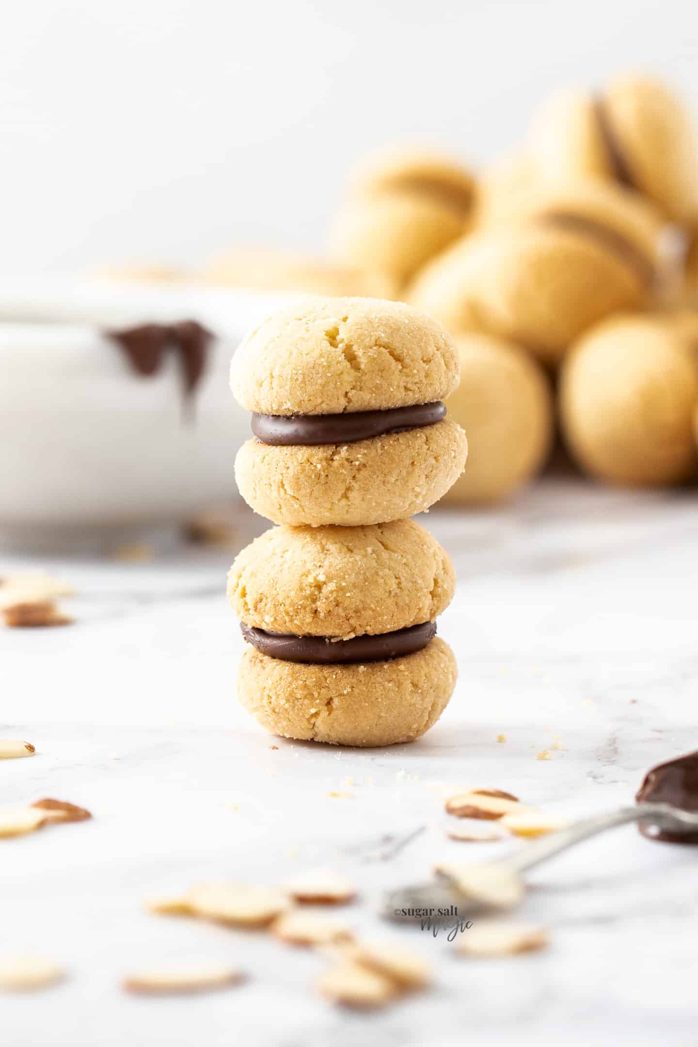 Two baci di dama cookies stack one on top of the other.