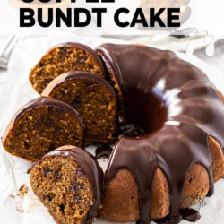 A bundt cake covered in chocolate ganache with slices sitting to the side.