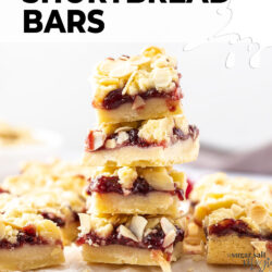 A stack of 4 shortbread bars filled with jam.