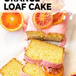 Top down view of an orange loaf cake with slices cut from it.