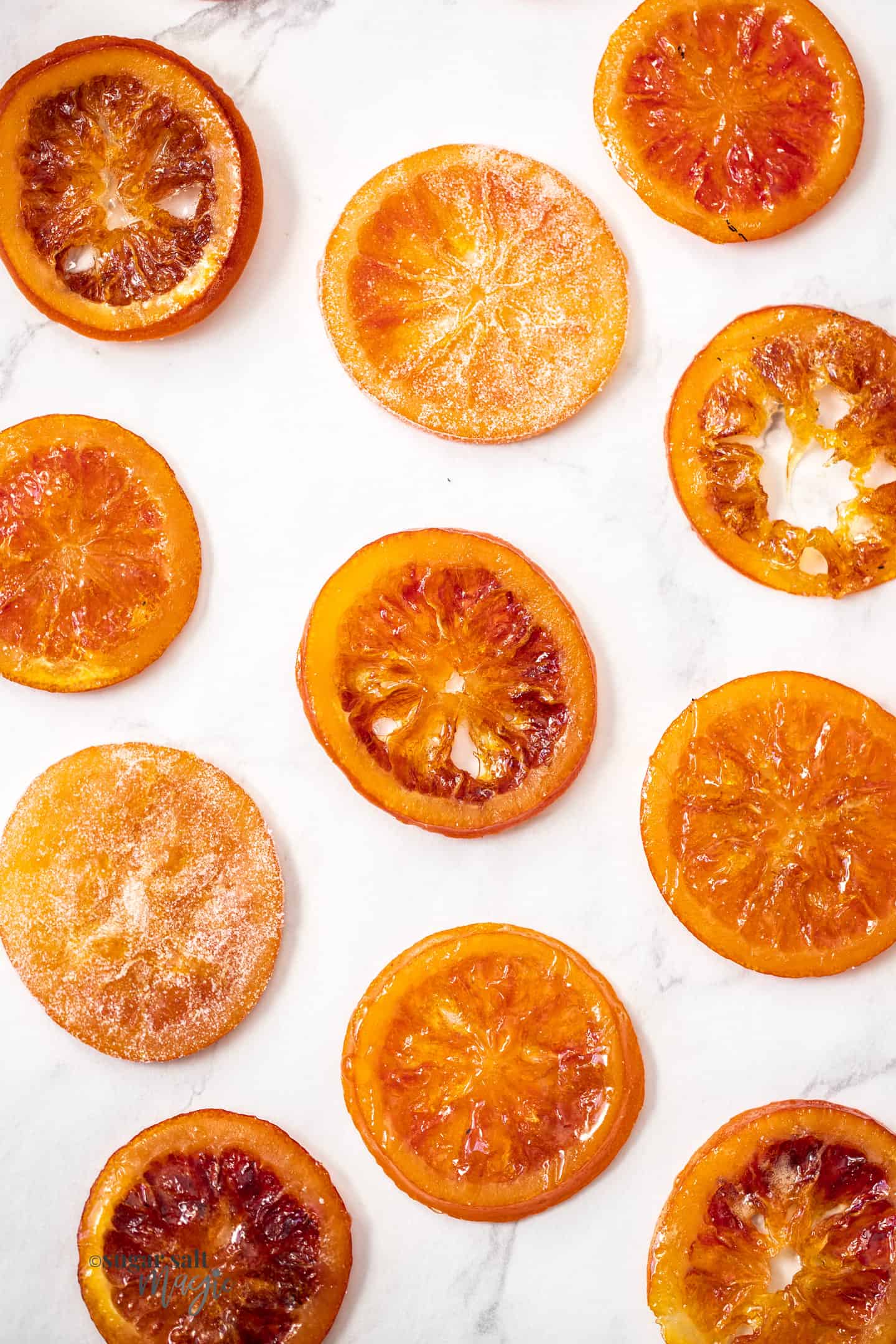 11 candied orange slices on sheet of baking paper.