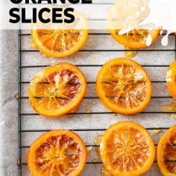 Top down view of 6 candied orange slices on a wire rack.