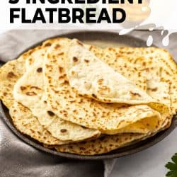 Some flatbreads folded on a brown plate.