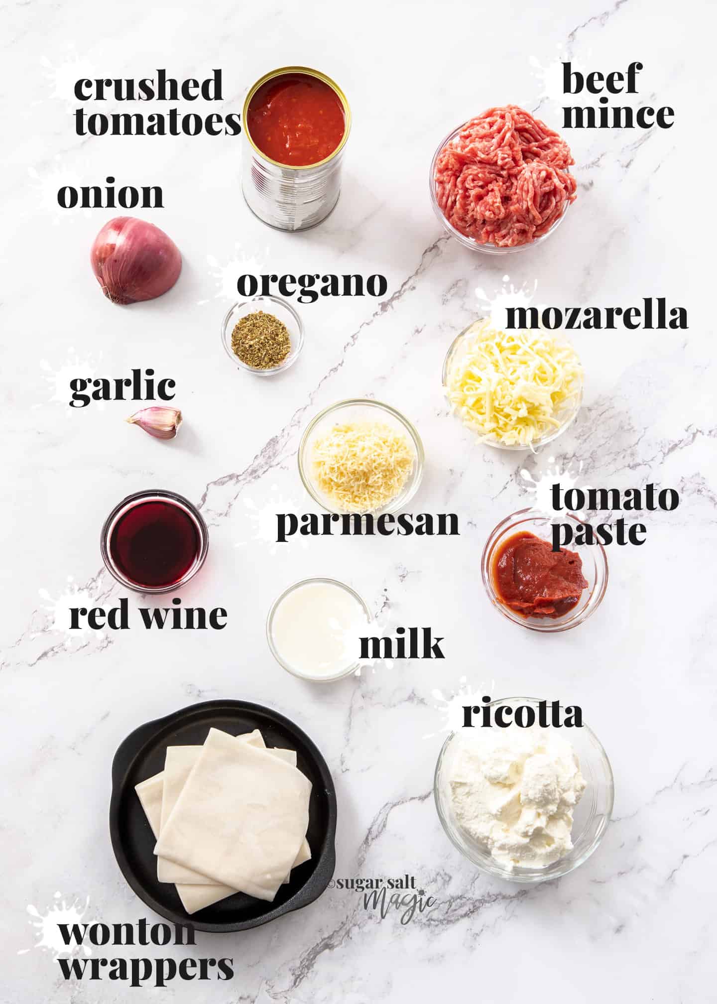 Ingredients for lasagna cupcakes on a white marble benchtop.