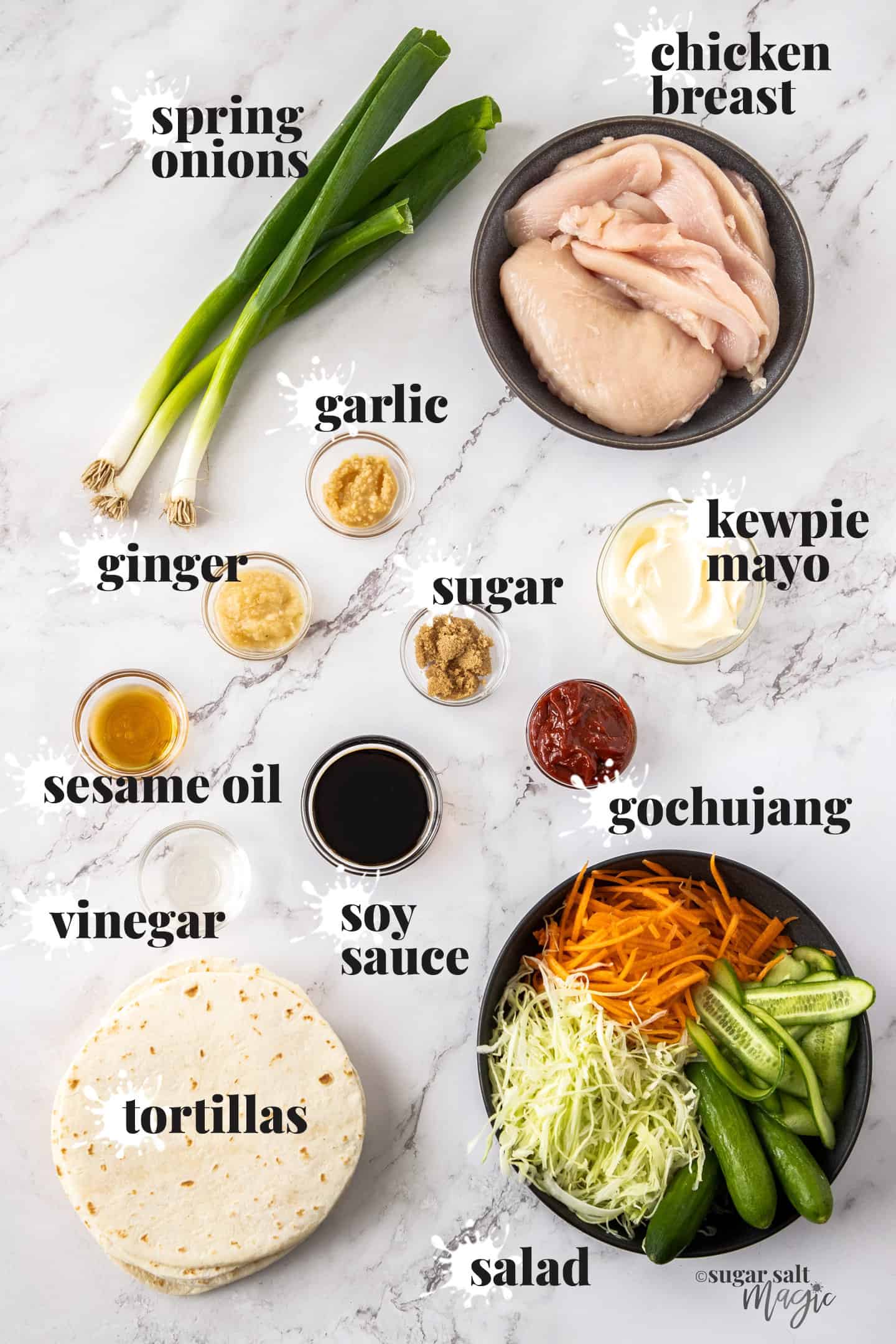 Ingredients for korean chicken tacos on a white marble benchtop.