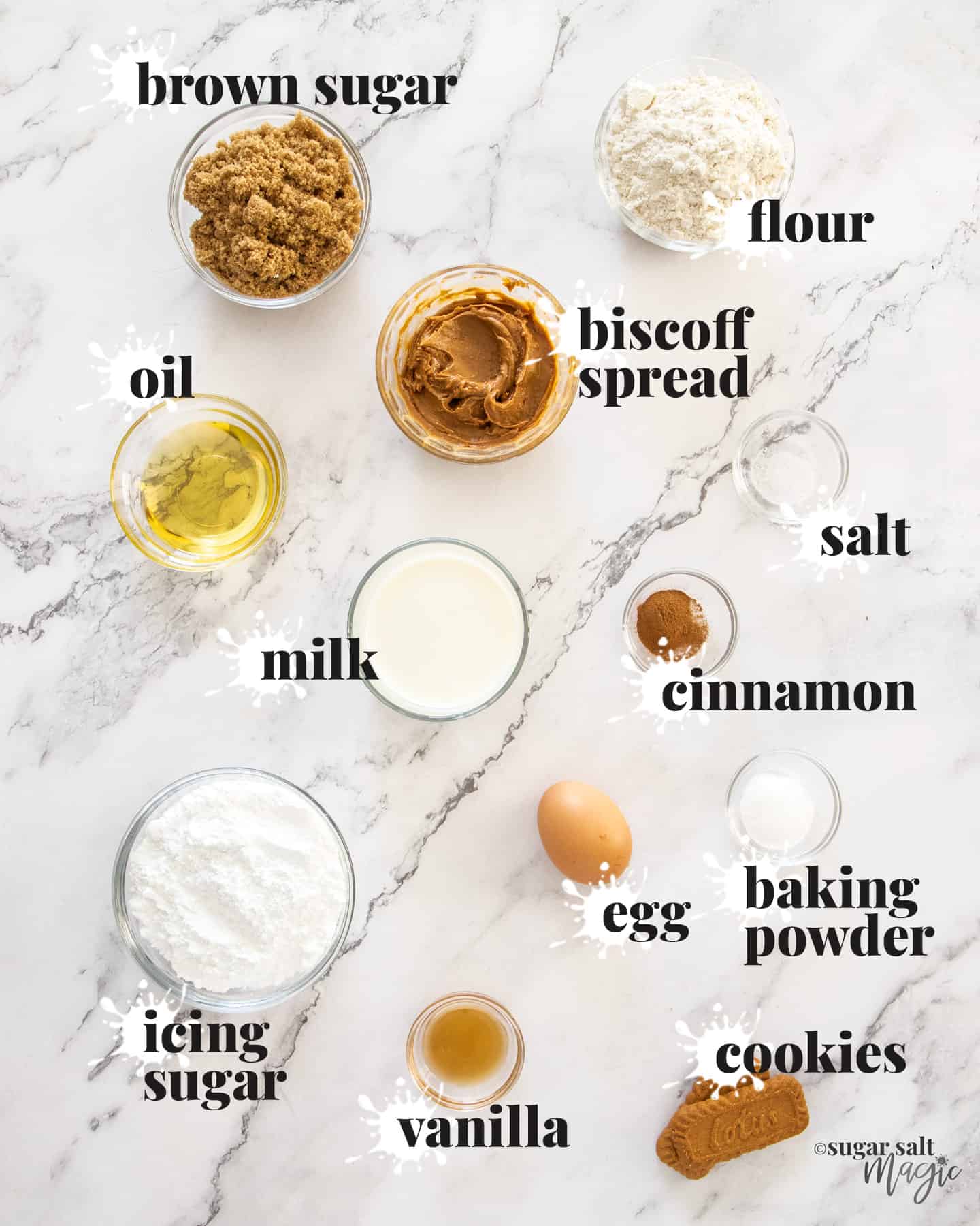 Ingredients for biscoff donuts on a white marble surface.