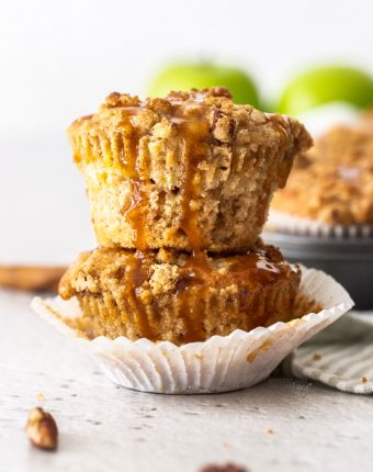 Two stacked muffins with caramel drizzling down the sides.