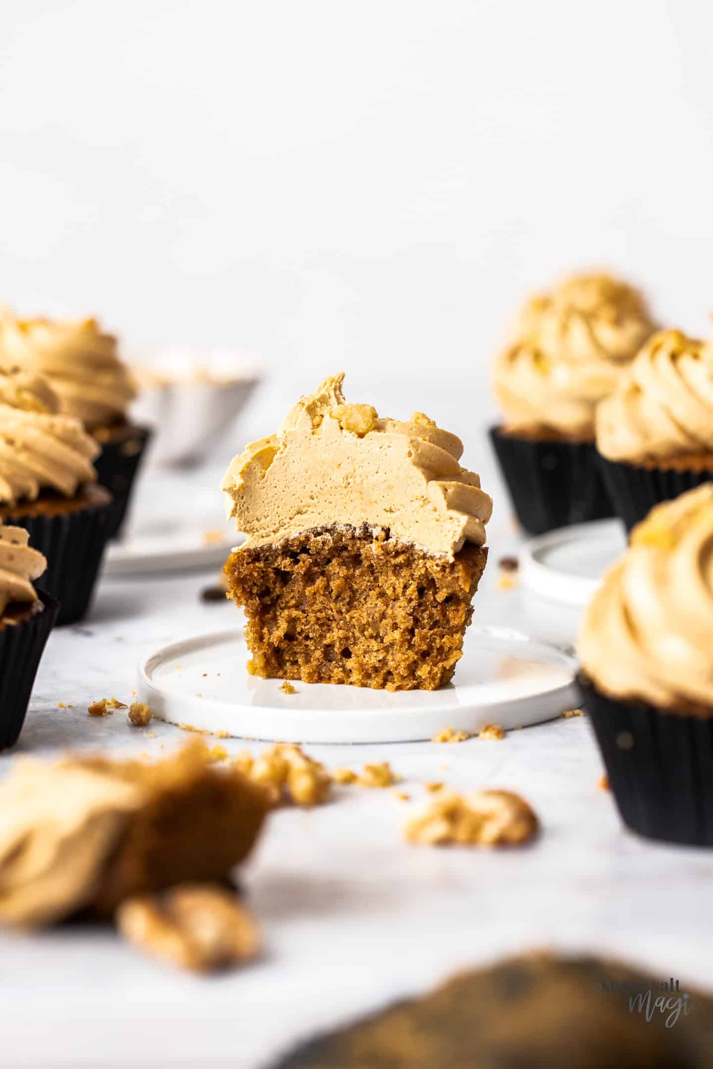 Closeup of a coffee cupcake that's been cut open to show the fluffy inside.