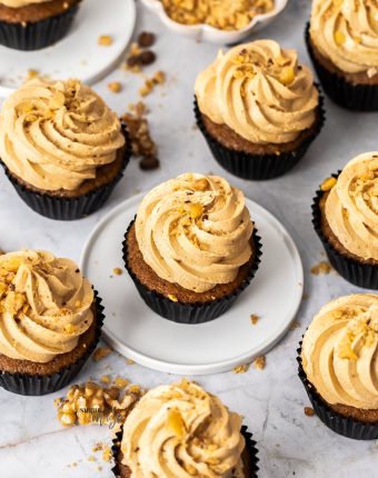 Top down view of 9 coffee and walnut cupcakes.
