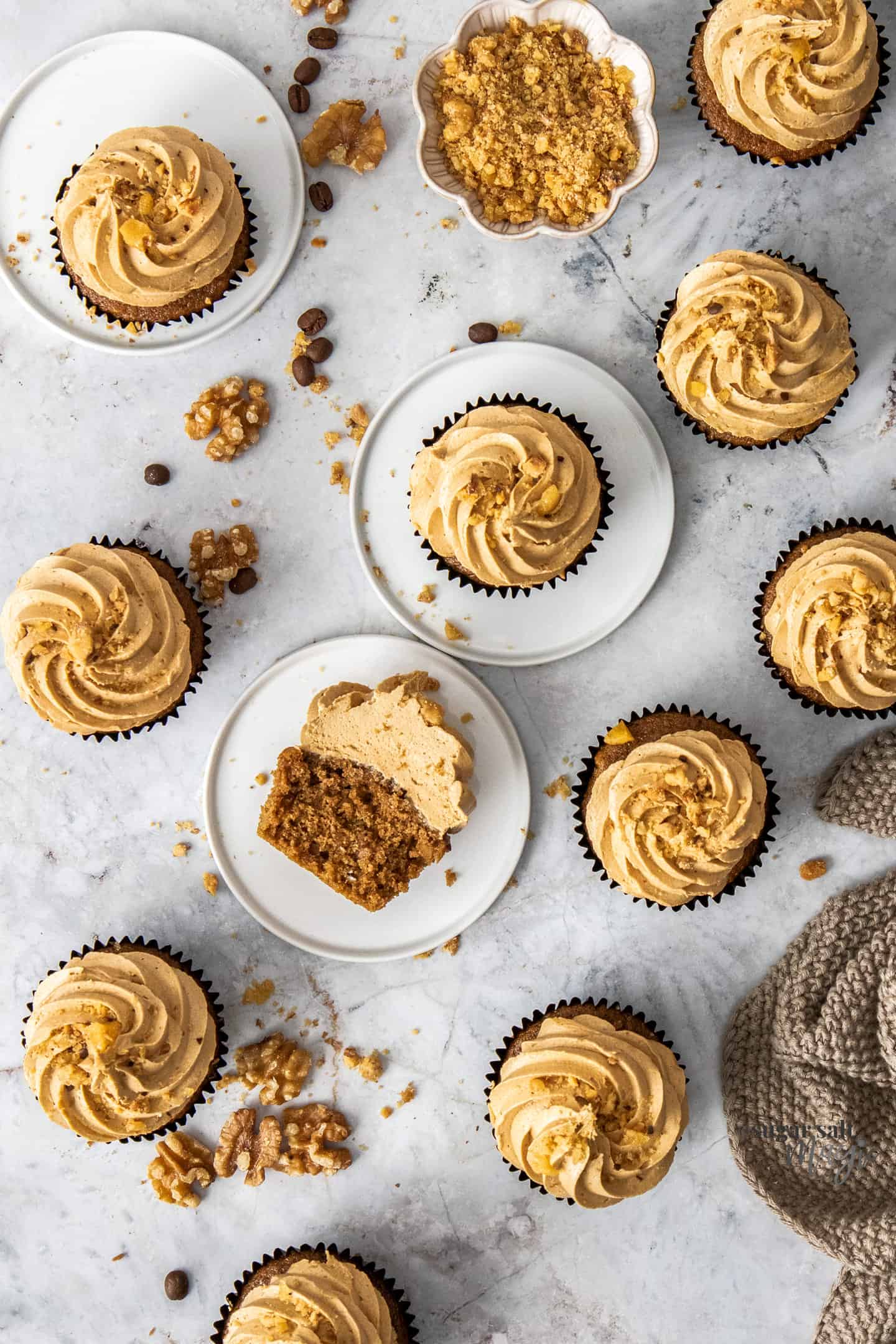 Top down view of a batch of coffee and walnut cupcakes.