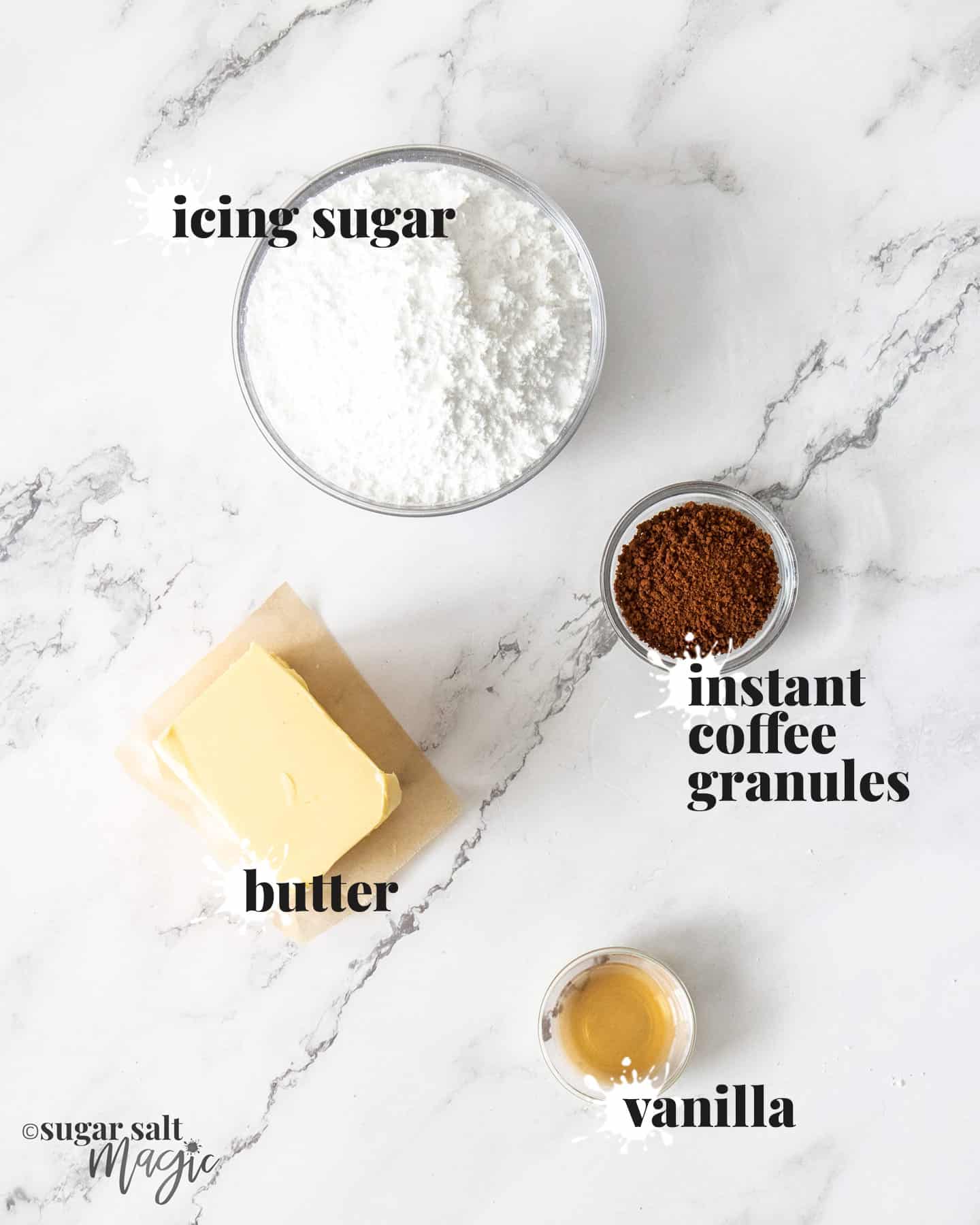 Ingredients for coffee buttercream on a white marble worktop.
