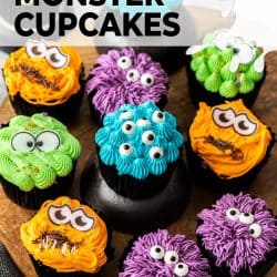 A variety of coloured monster cupcakes on a wooden platter.