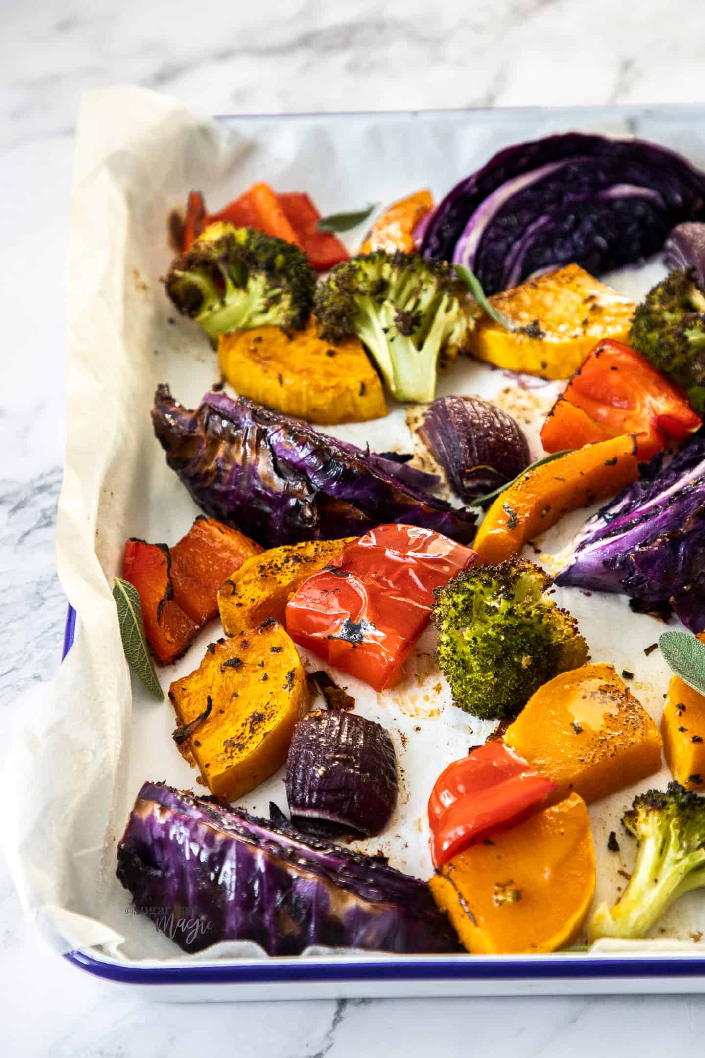 A sheet pan filled with colourful roasted vegetables.