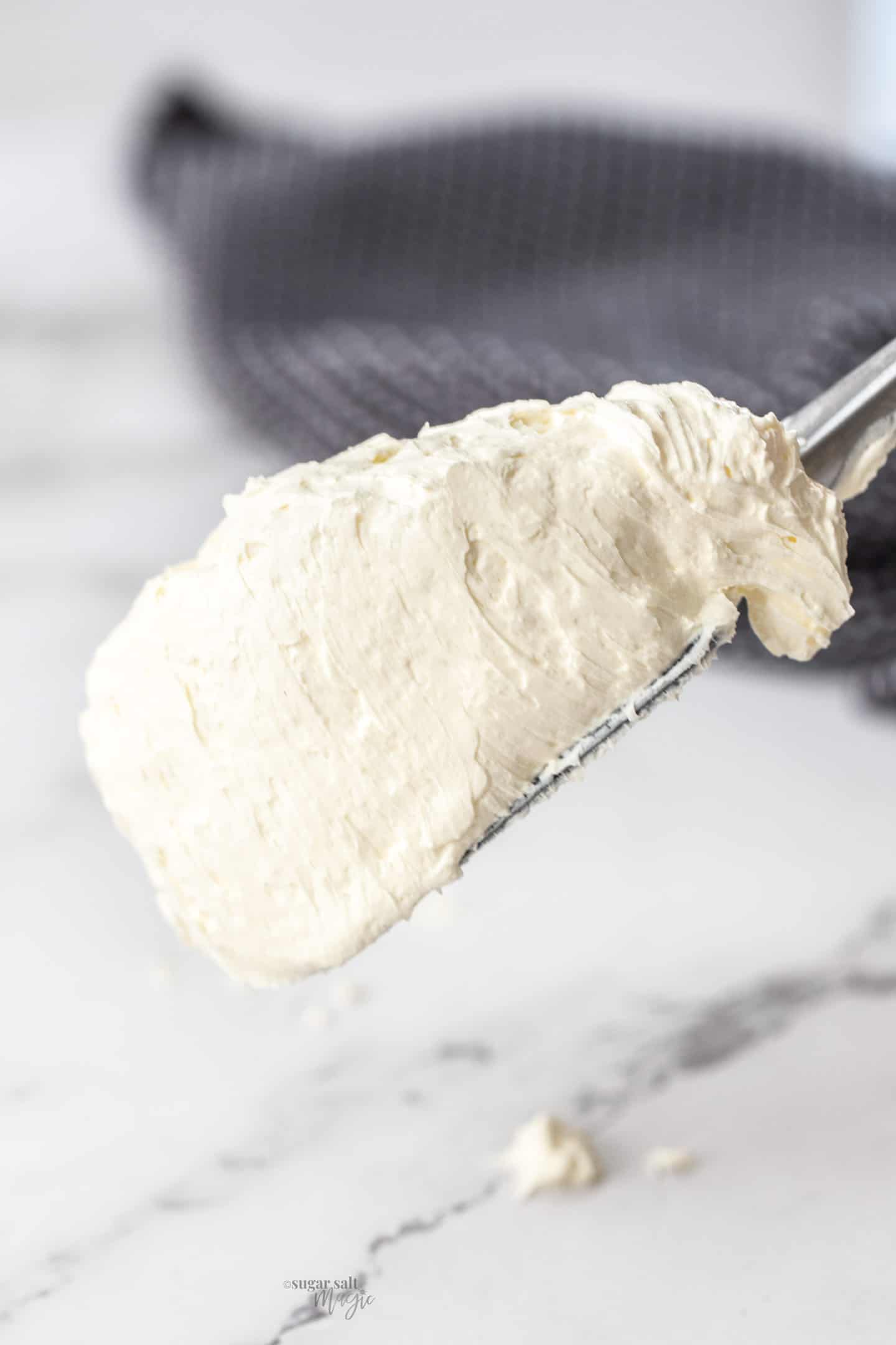 A spatula loaded with Swiss meringue buttercream.