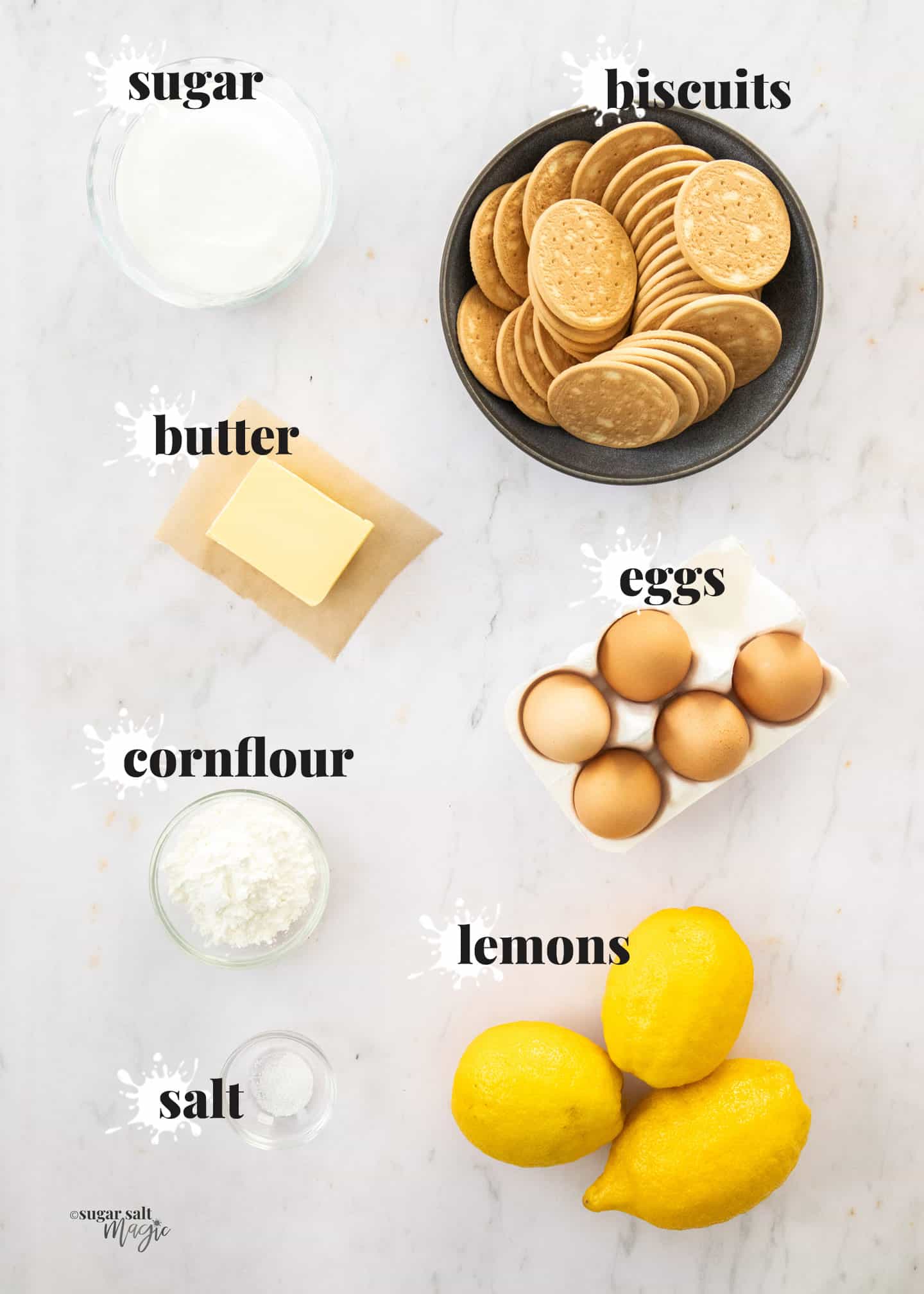 Ingredients for lemon meringue pie on a white marble surface.