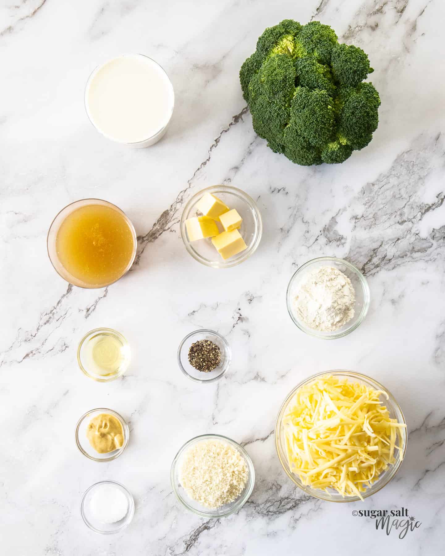 Ingredients for broccoli cheese bake on a marble bench.