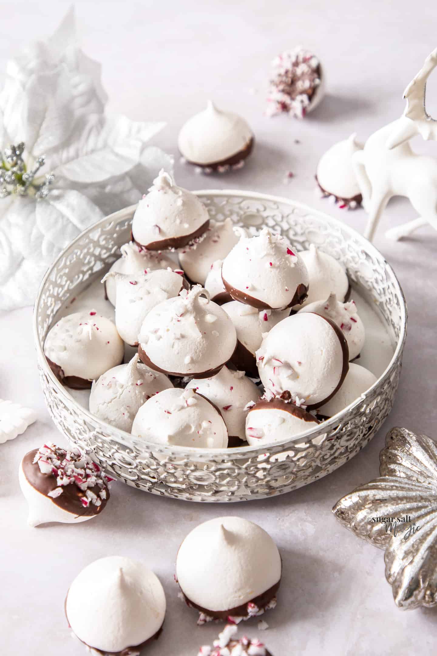 A small round white tin filled with peppermint meringues.