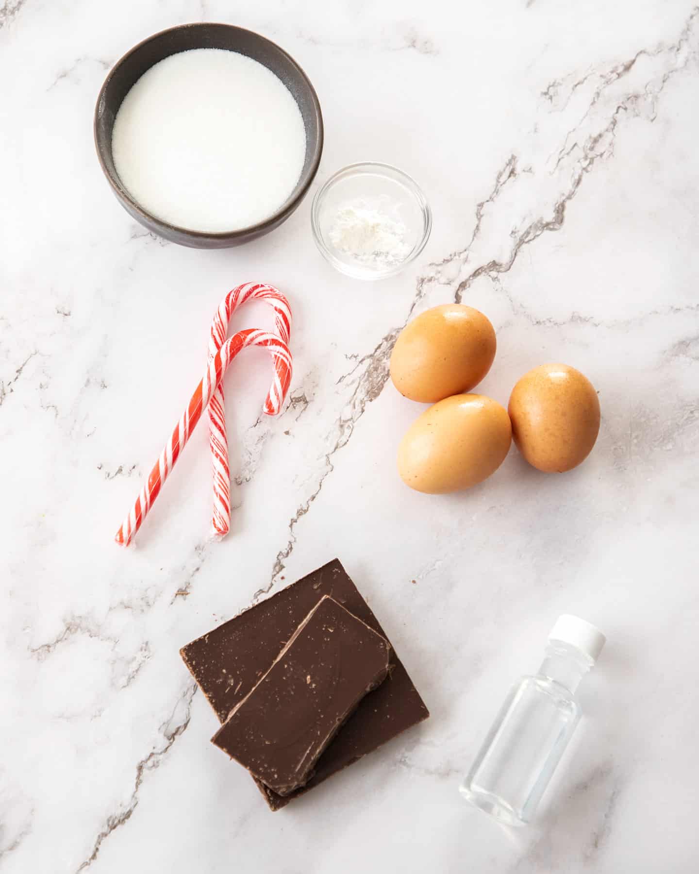 Ingredients for peppermint meringues on a marble benchtop.