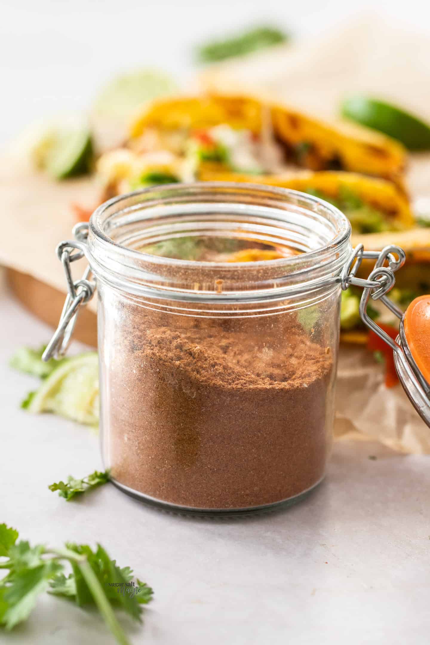 A small jar filled with taco seasoning.