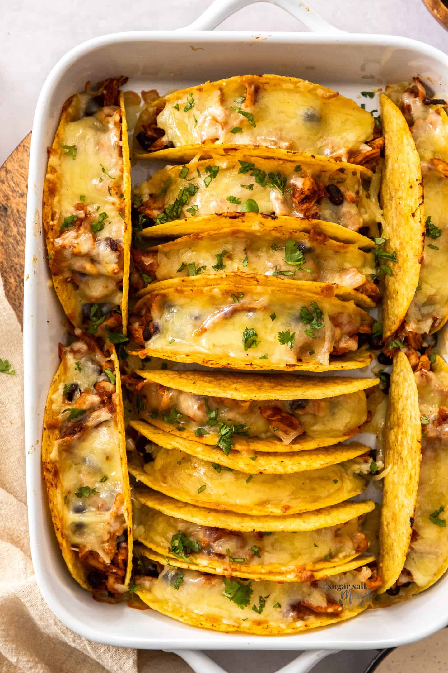 Baked tacos in a baking dish.
