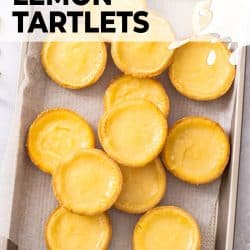 A gold tray filled with lemon tartlets.