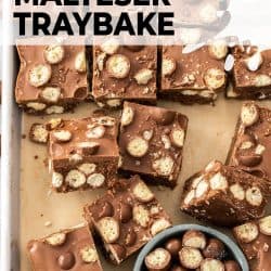 Squares of Malteser traybake on a baking tray.